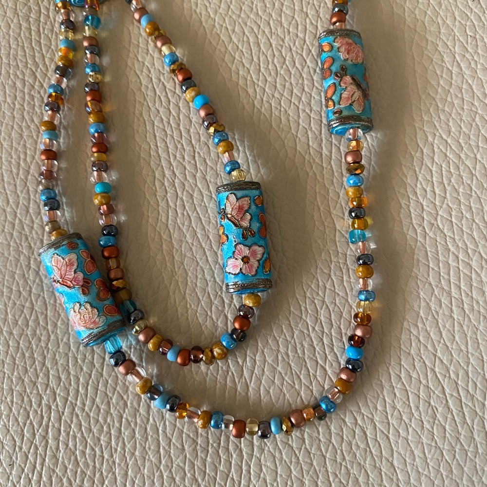 Necklace featuring colorful cloissone beads and  seed beads. 32 in